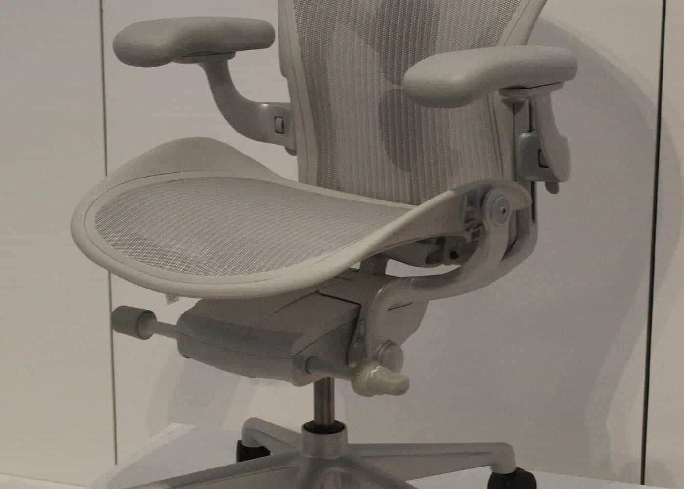 A white ergonomic office chair with adjustable armrests